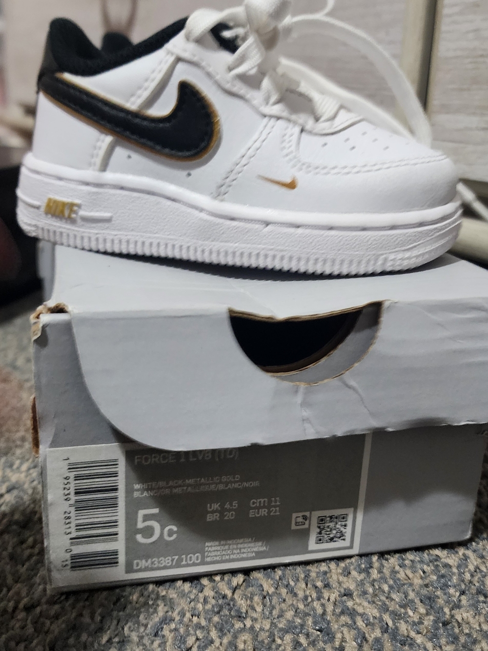 Nike Kids' White and Black Sneakers with Gold Accent